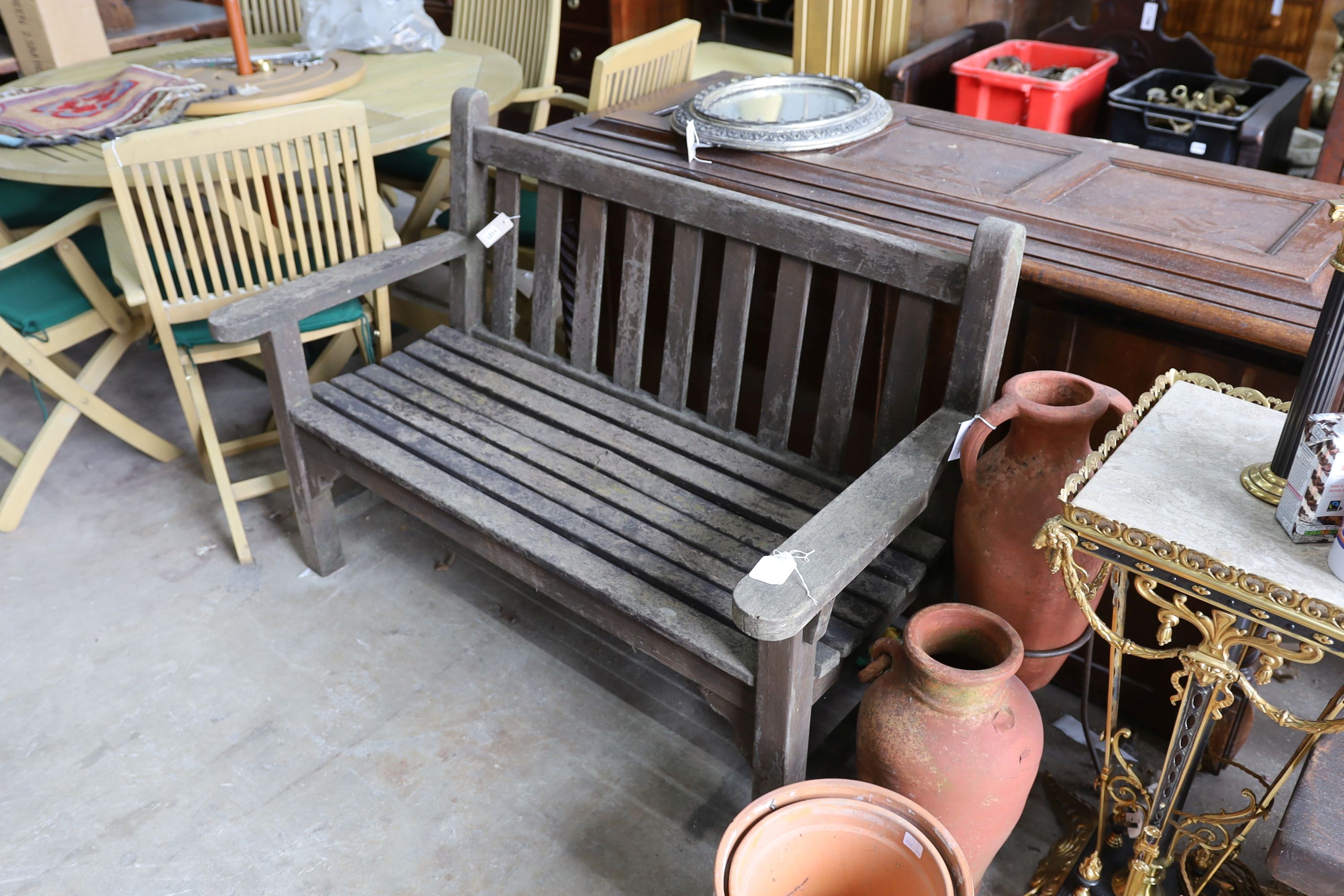 A weathered teak slatted garden bench, length 128cm, depth 62cm, height 91cm